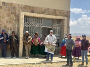 A group of men and women in Bolivia conversing outside the musuem, showcasing community and interaction