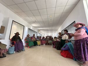 Large group of Bolivian women sitting in a meeting in the Culli Alto museum